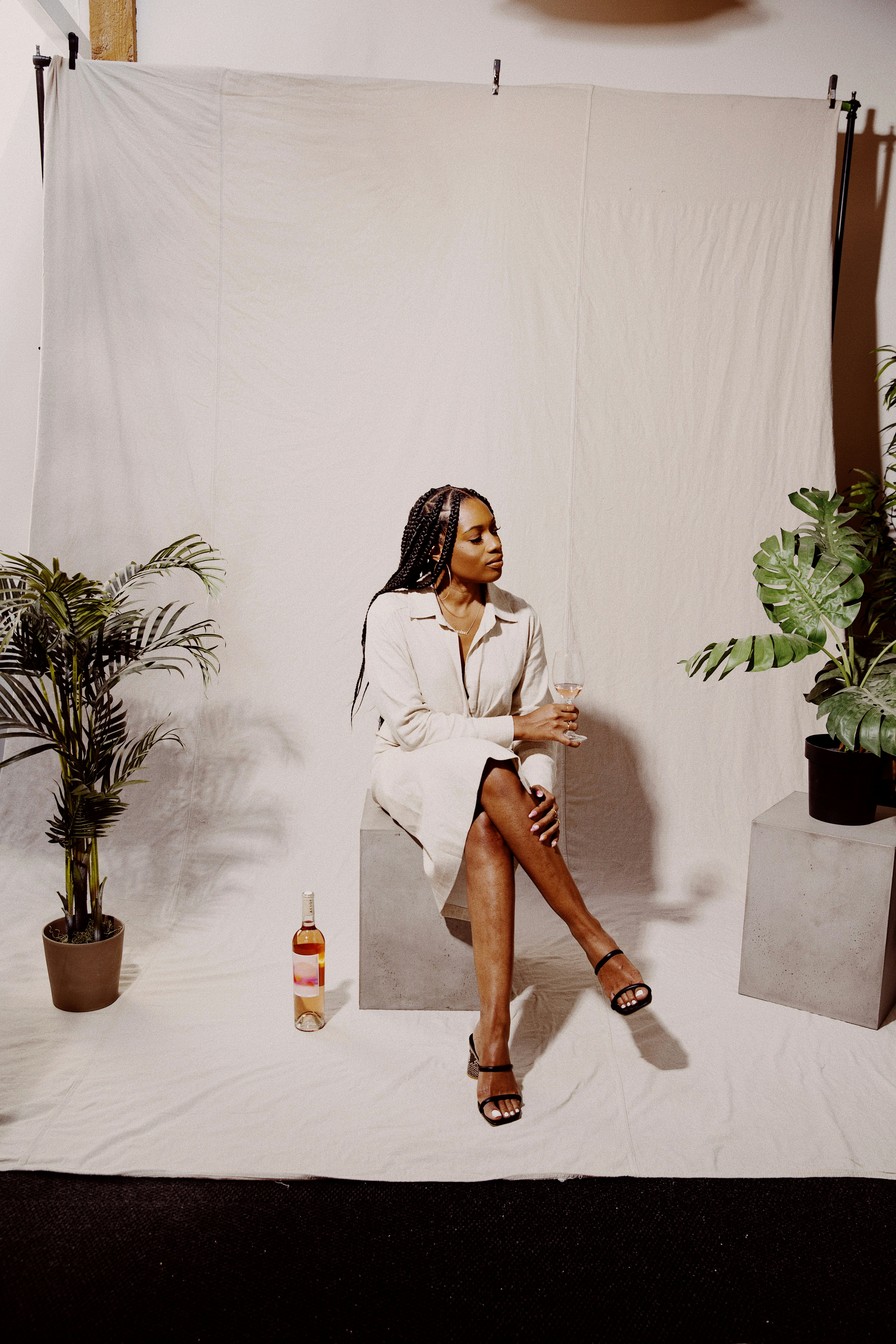 woman in white long sleeve shirt and brown pants sitting on brown wooden seat